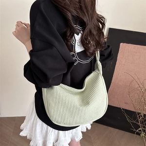Minimalist light green corduroy crescent tote bag with knot shoulder strap detail