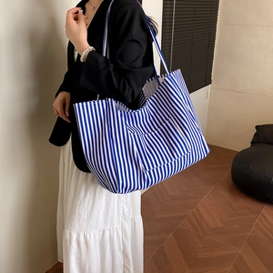 Blue and white striped canvas tote bag for women featuring large capacity and shoulder strap