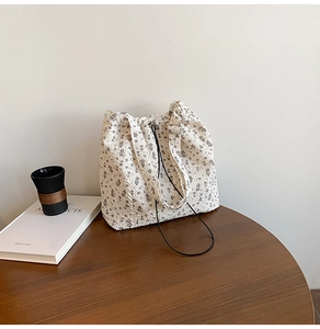 Detail of floral tote bag showing textured seersucker fabric and drawstring element