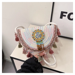 Detail of bohemian saddle bag with colorful fringe tassels and bead embroidery