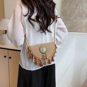 Bohemian woven straw shoulder bag with colorful tassels and artistic round ornament