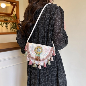 Bohemian rainbow woven crossbody bag with colorful tassels and ethnic beaded detail