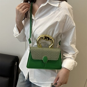 Green leather crossbody bag with woven texture lid and golden ring handle