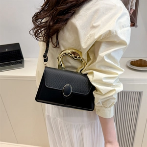 Elegant black leather handbag with unique gold handle for women, crossbody style