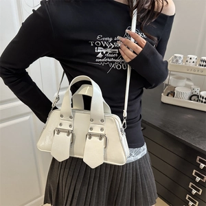 Chic white patent leather handbag with metal buckle straps and detachable crossbody strap