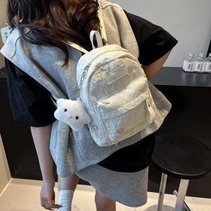 Minimalist white quilted mini backpack with colorful embroidery and star plush pendant