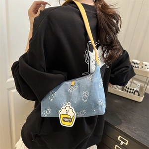 Blue denim shoulder bag with white bear prints and a bright yellow leather strap