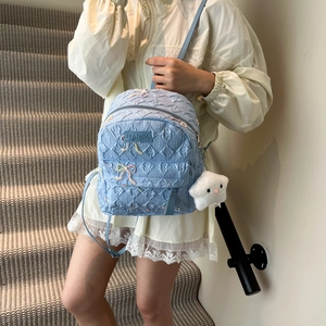 Light blue quilted backpack with bow embroidery and plush star charm for school girls