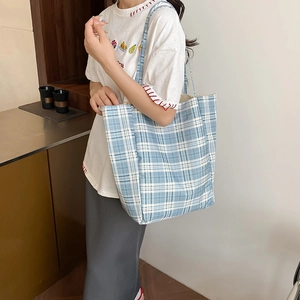 Minimalist large capacity blue and white plaid tote bag for women shown on a model