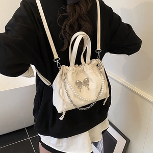 Chic butterfly drawstring backpack in cream canvas with pearl and silver chain details
