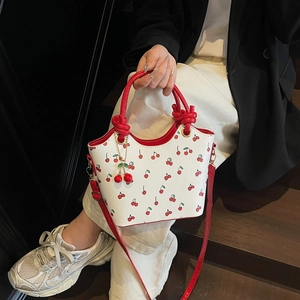 Retro white leather bucket bag with red cherry prints and matching shoulder strap