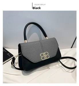 Detail of contrast stitching with grey fabric and golden double B buckle on shoulder bag