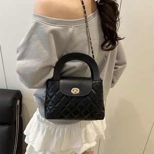 Classic black quilted crossbody bag with golden ring clasp and metal chain strap