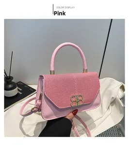 Detail of pink shoulder bag featuring woven pattern flap and golden B-shaped buckle