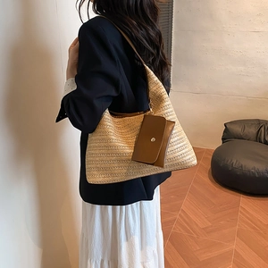 Large straw woven tote bag with brown leather straps and pouch for summer fashion