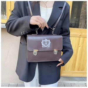 Detailed view of the school style JK bag's adjustable strap and metal buckle fasteners