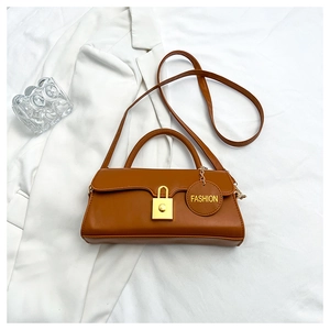 Detail view of a brown vintage shoulder bag featuring a gold metal clasp and fashion tag