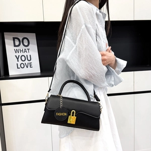 Chic black matte PU leather shoulder bag with gold clasp and fashion tag on white background