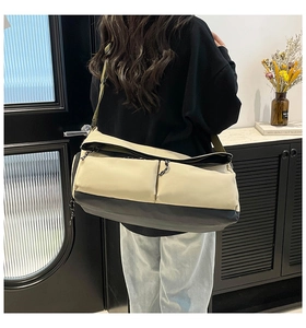 Detail of multi-functional travel bag with dual front pockets and adjustable strap