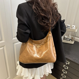 Minimalist brown hobo tote bag for women with polished faux leather and metal emblem detail