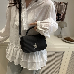 Quilted black mini shoulder bag with sparkling silver rhinestone star and chain strap