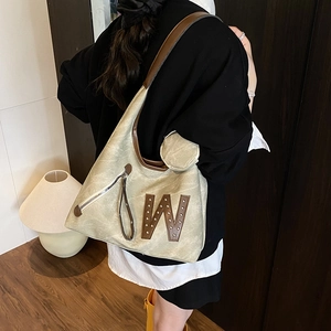 Retro large light green tote bag with brown trim and shoulder strap in casual setting