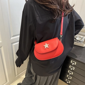 Red crossbody bag for women with silver star detail on a minimalist semicircular design