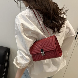 Chic red quilted chain shoulder bag with metal buckle closure for women