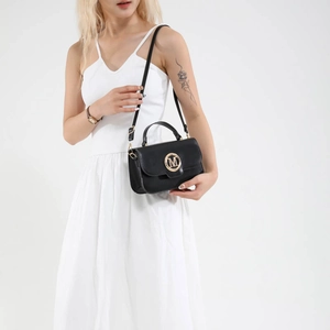 Chic black leather crossbody bag with golden M logo and adjustable shoulder strap