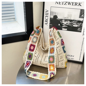Detail of hand-woven crochet shoulder bag with colorful floral patterns in boho style
