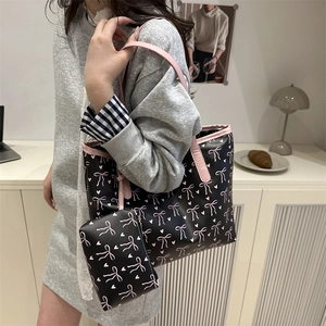 Large capacity black tote bag with pink bow pattern and matching zipper pouch set