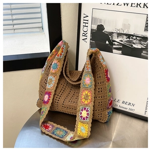 Detail of bohemian hand-woven crochet bag with colorful floral granny square straps