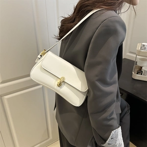 Minimalist white leather underarm bag with gold cylindrical metal lock for stylish women