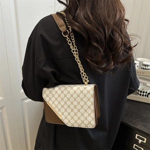 Chic beige monogram flap shoulder bag with gold chain strap worn by a female model