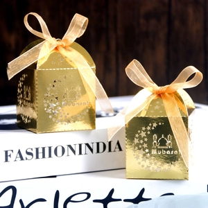 Detailed laser-cut gold gift boxes with moon and star patterns and satin ribbons