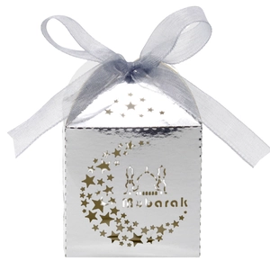 Detailed laser-cut silver candy box with star moon patterns and blue ribbon bow