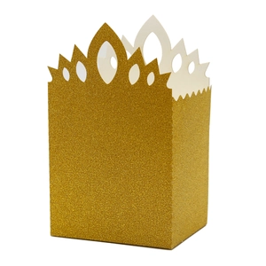 Macro detail of golden glitter gift box featuring a hollow-out crown top and matte texture