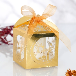 Detail of golden Eid Mubarak chocolate box with laser-cut moon, stars and ribbon