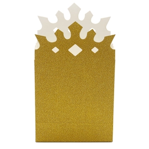 Macro detail of golden glitter crown party favor box with intricate cutout design