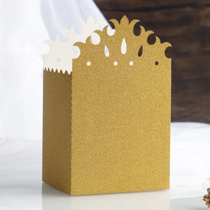Detail of glitter gold hollow crown gift box with textured shimmer surface for weddings