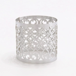 Close-up of silver hollow floral patterned napkin ring with intricate European carving