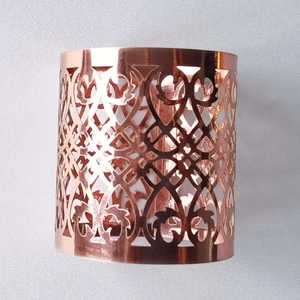 Detailed macro view of rose gold napkin ring with intricate European hollow patterns