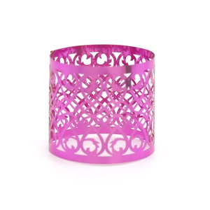 Detailed view of magenta hollowed-out metal napkin ring with laser-cut geometric patterns