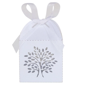 Detail of ivory laser-cut tree of life candy box with elegant white ribbon bow
