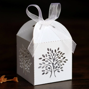Detailed laser cut tree of life ivory candy box with elegant white organza ribbon