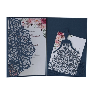 Close-up of laser cut floral hollow design and elegant silhouette on navy wedding invitation