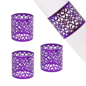 Elegant purple laser-cut napkin ring with floral scroll patterns for wedding decor