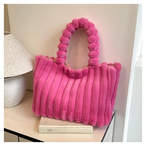 Detail of plush faux fur tote bag in rose red with vertical stripes and bubble handles