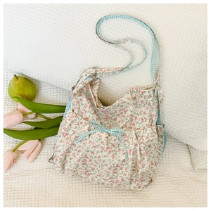 Floral print shoulder bag detail with bow drawstring and blue checkered pattern trim