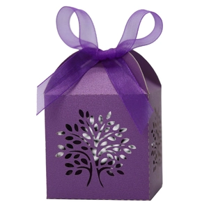 Detail of purple laser-cut gift box featuring Tree of Life pattern and organza ribbon